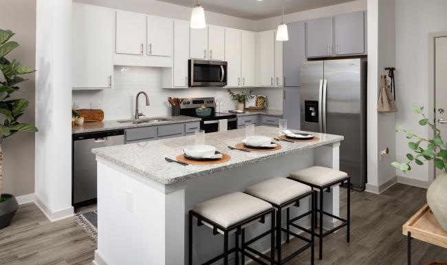 a kitchen with stools and island